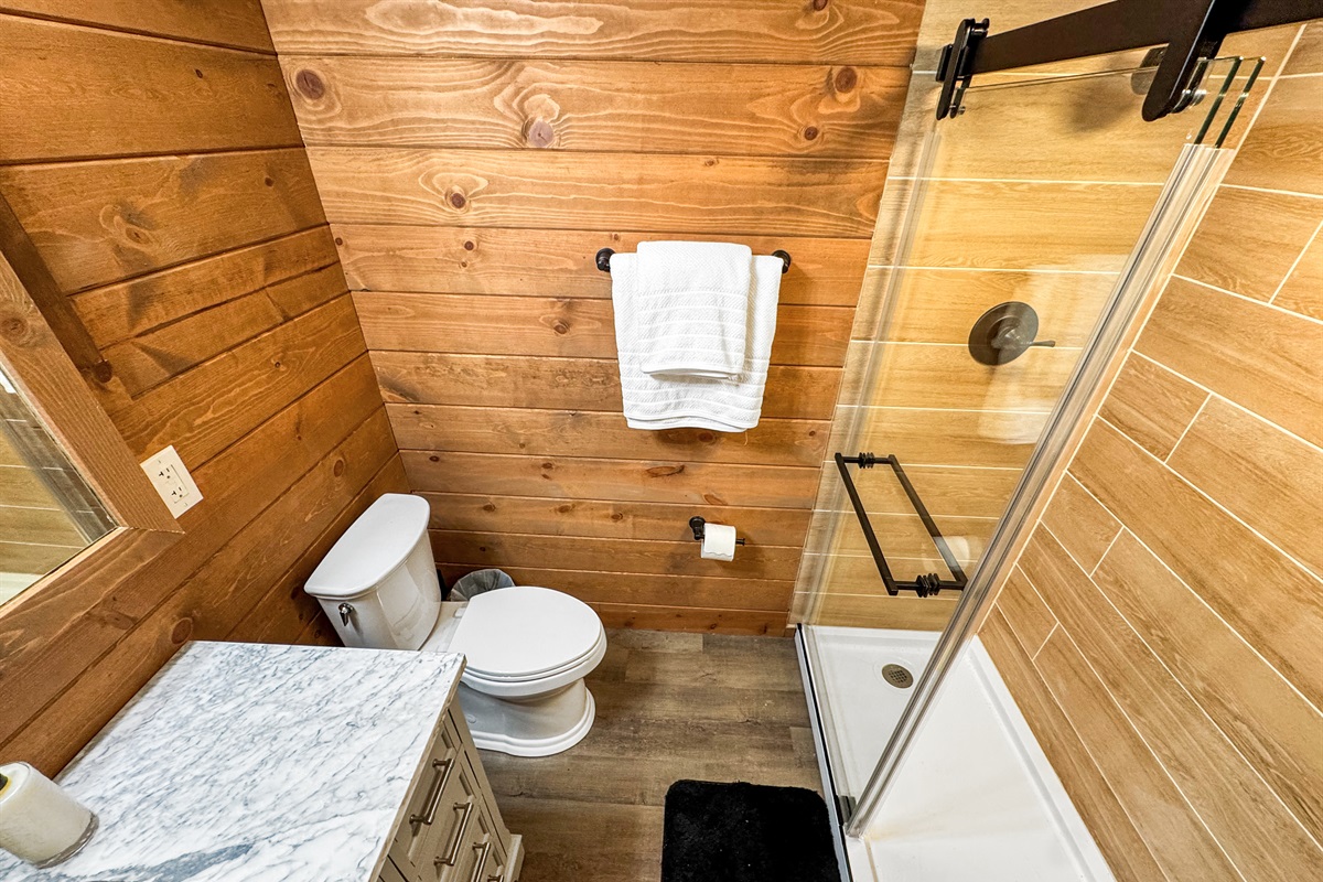 Bathroom Retreat: Elegant marble vanity and sleek glass shower invite relaxation after adventures!