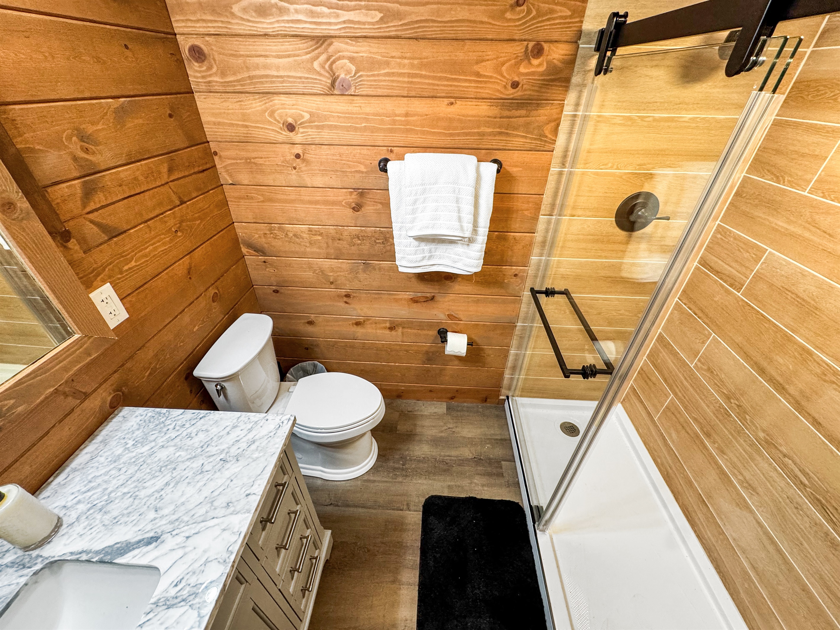 Bathroom Retreat: Elegant marble vanity and sleek glass shower invite relaxation after adventures!