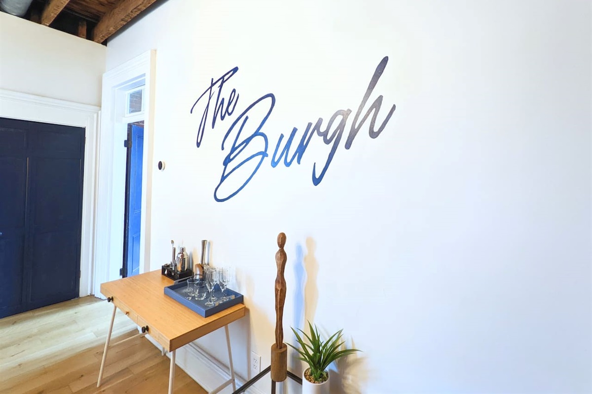 A beautifully designed dining space with a long table, six chairs, and an extra cushioned seat. This spacious yet cozy area, with its simple elegance, is ideal for family dinners, friendly get-togethers, or relaxing moments over your favorite meals.