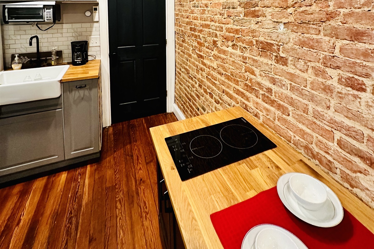 Ensuite Kitchenette. Equipped with toaster/convection oven, microwave, utensils, silverware, pot/pans, electric double cook top, refrigerator/freezer, sink.