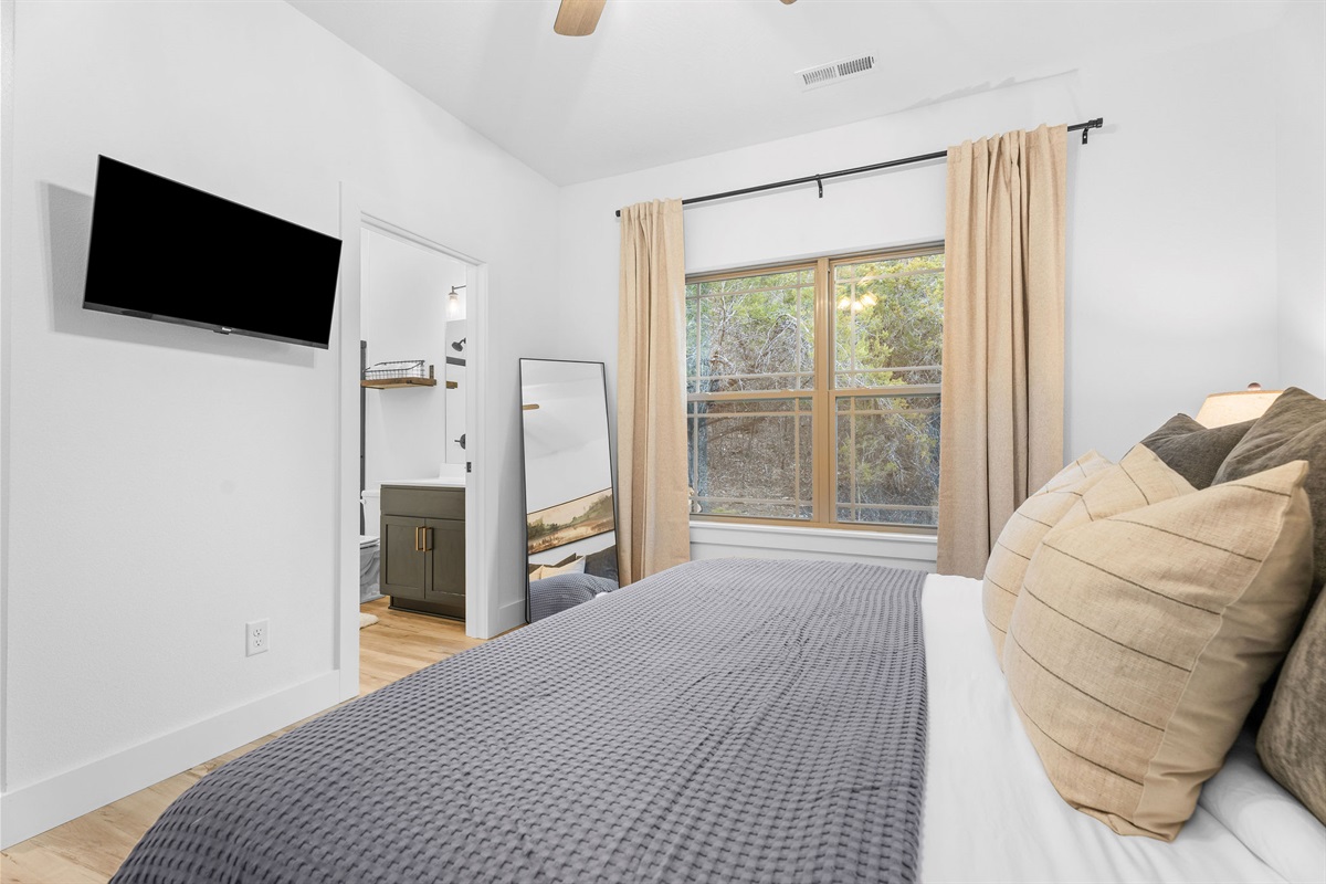 Bright and peaceful bedroom with natural light and space to relax.