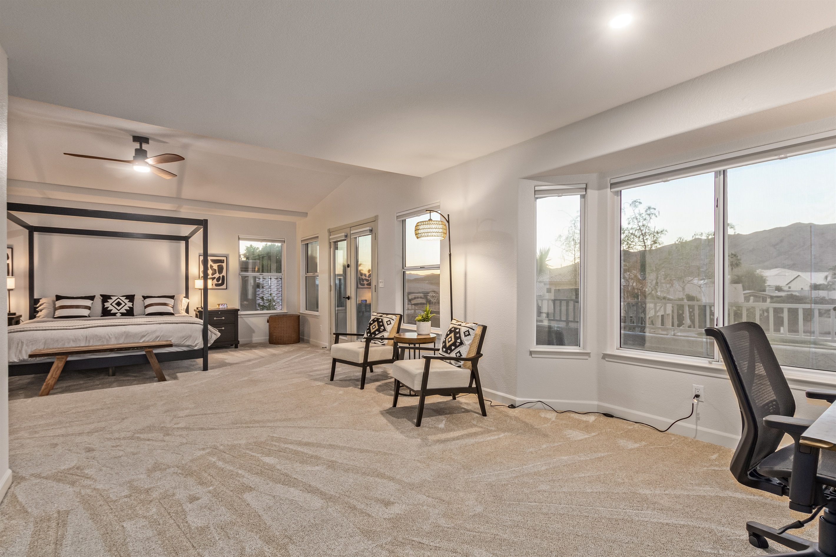 Extra large primary bedroom with king bed, 65" TV, walk in closet, sitting area, remote workspace, private deck, ensuite bathroom, linens and extra pillows and blankets