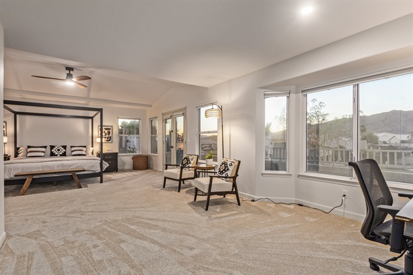 Extra large primary bedroom with king bed, 65" TV, walk in closet, sitting area, remote workspace, private deck, ensuite bathroom, linens and extra pillows and blankets