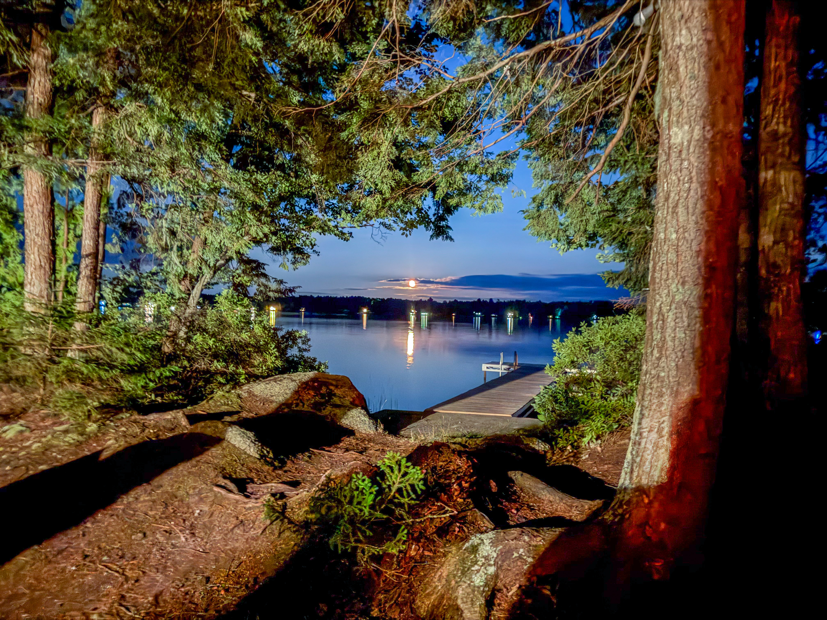 Enjoy night access at Loonrise Point! Exterior grounds lighting illuminates the pine path and granite rocks down to your private dock. Walk down safely after dark to watch the moon rise over Beech Hill Pond in peaceful Otis, ME.
