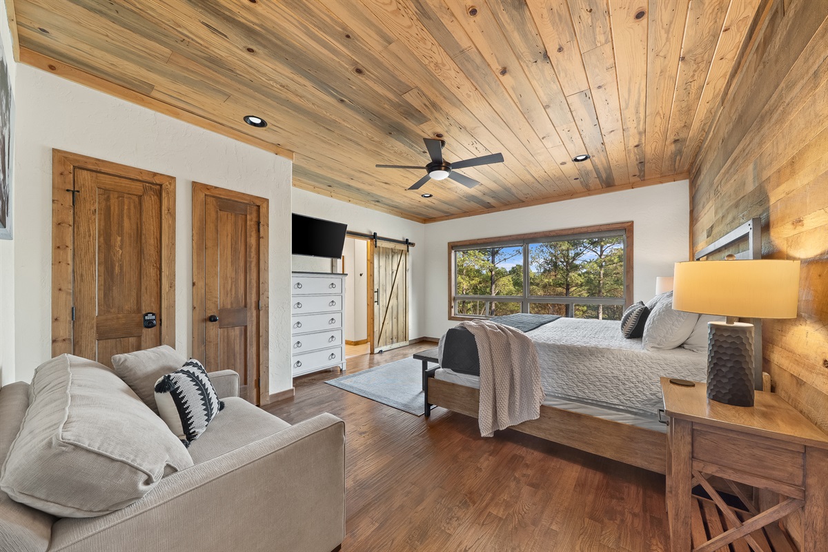 Upstairs king ensuite bedroom with ensuite bathroom and foldout sleeper chair.