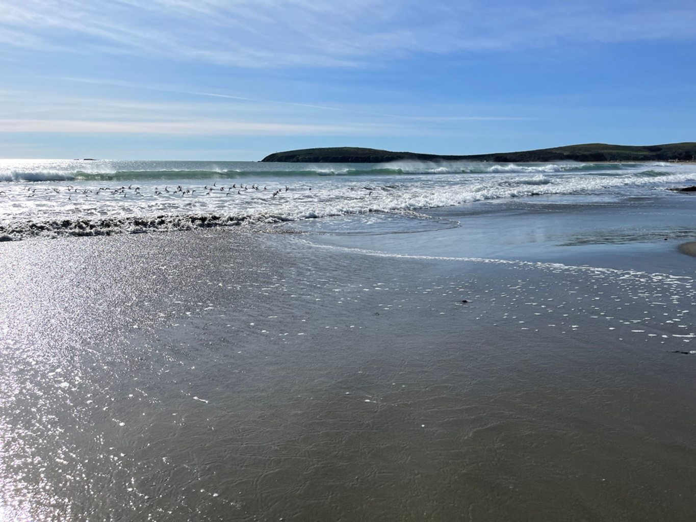 Sunlight reflecting on shallow water near the beach