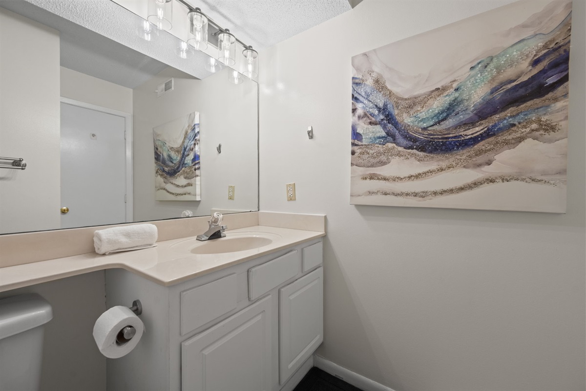 Spacious vanity area with ample counter space and bright lighting for your daily routine