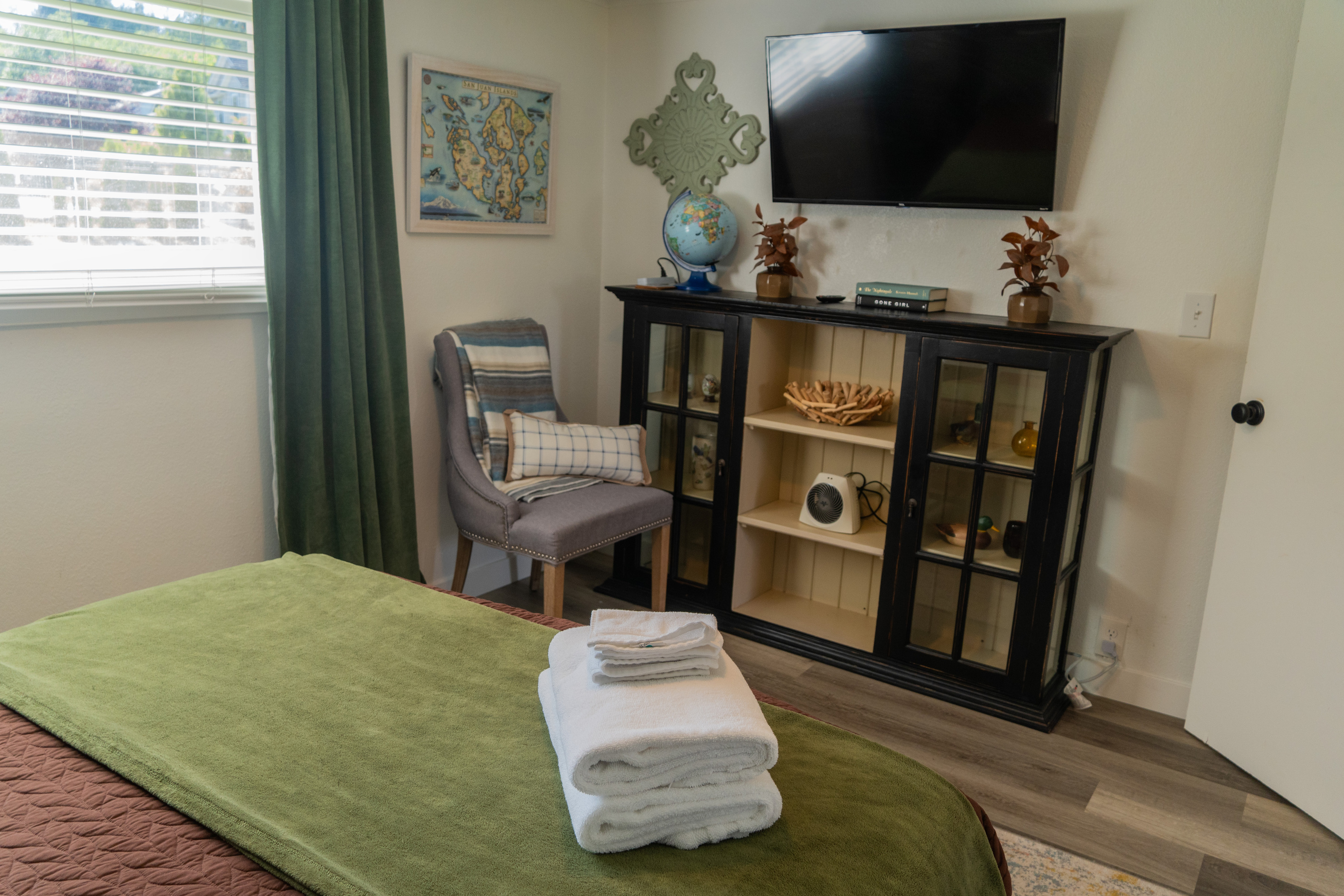 A queen bedroom with a TV for cozy movie nights, surrounded by subtle nature-inspired details that make the space warm and inviting.