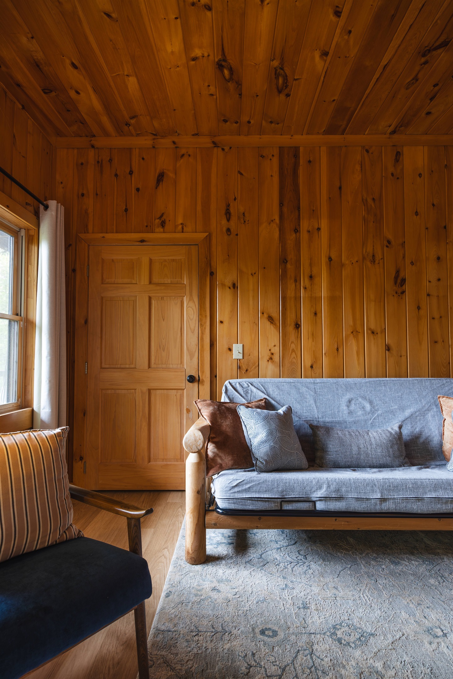 A peaceful lower-level suite that feels like its own quiet cabin escape. Stretch out in a plush king bed, stream your favorites on the Roku TV, & relax in the futon or reading chair after a day in the mountains. A closet and dresser provide easy storage.