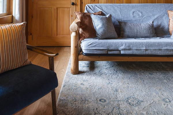 A peaceful lower-level suite that feels like its own quiet cabin escape. Stretch out in a plush king bed, stream your favorites on the Roku TV, & relax in the futon or reading chair after a day in the mountains. A closet and dresser provide easy storage.