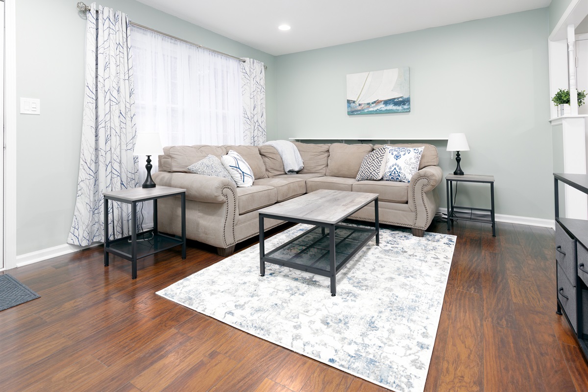 Living room seating area with comfortable furnishings and natural light.