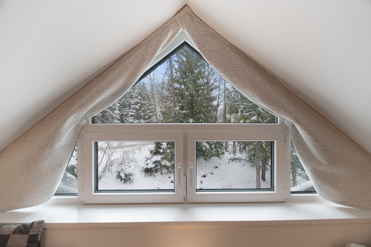 A-frame window overlooking forest and creek