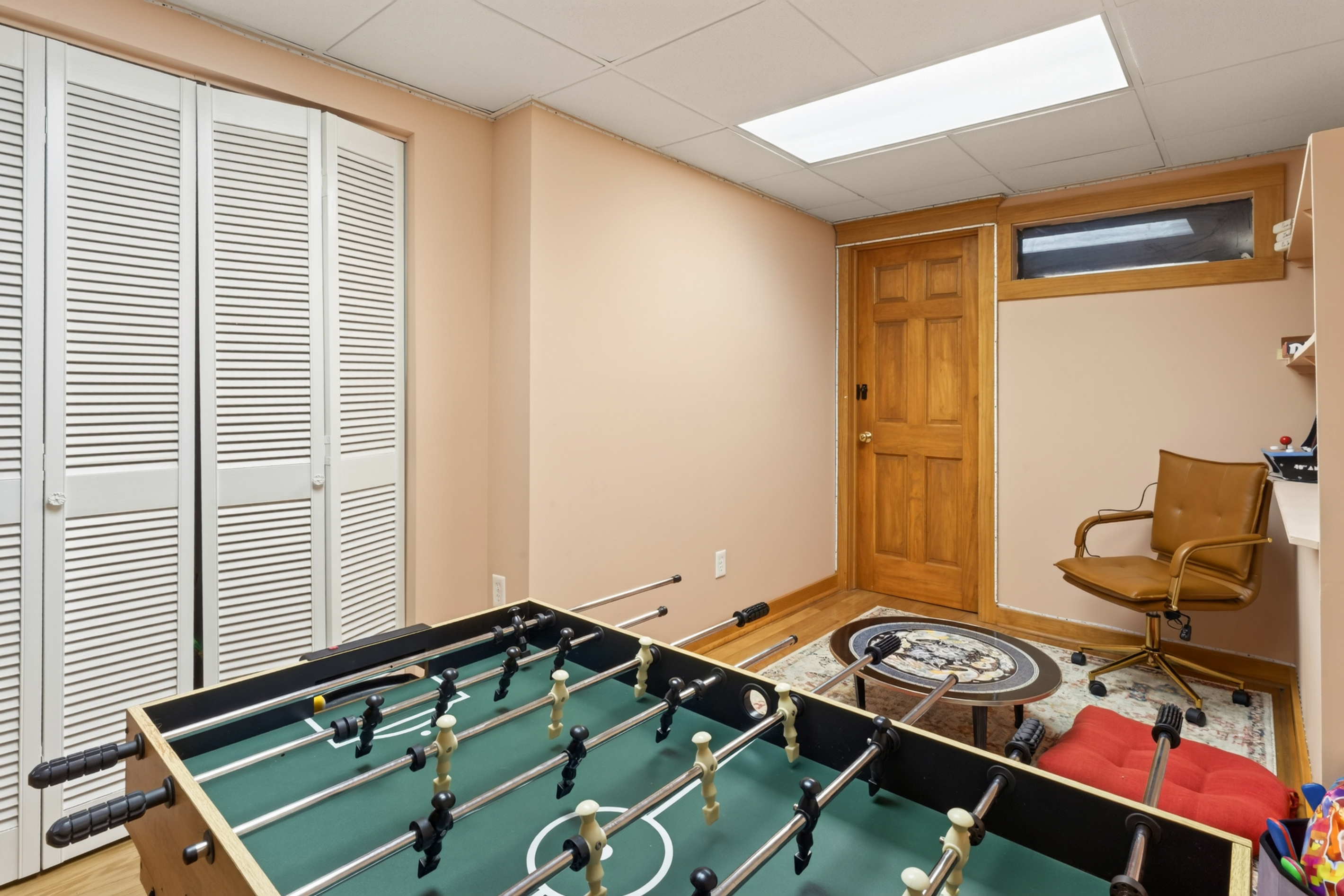 Foosball table beside lounge seating