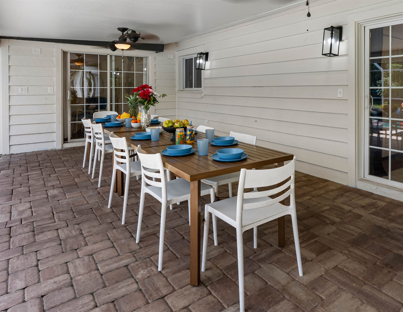 Featuring an extended dining space and poolside seating, this screened enclosure is perfect for both quiet mornings and lively evenings.