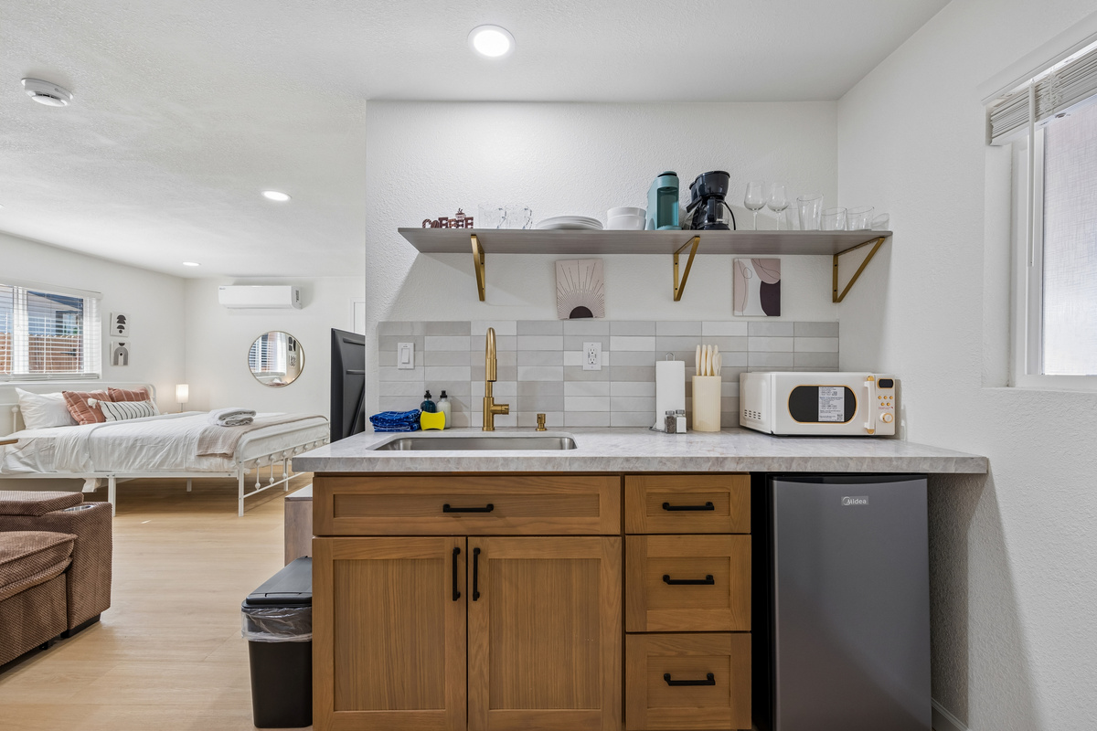 This fully stocked kitchenette comes with all you need to cook basic meals.  The 2-burner cooker is under the sink.