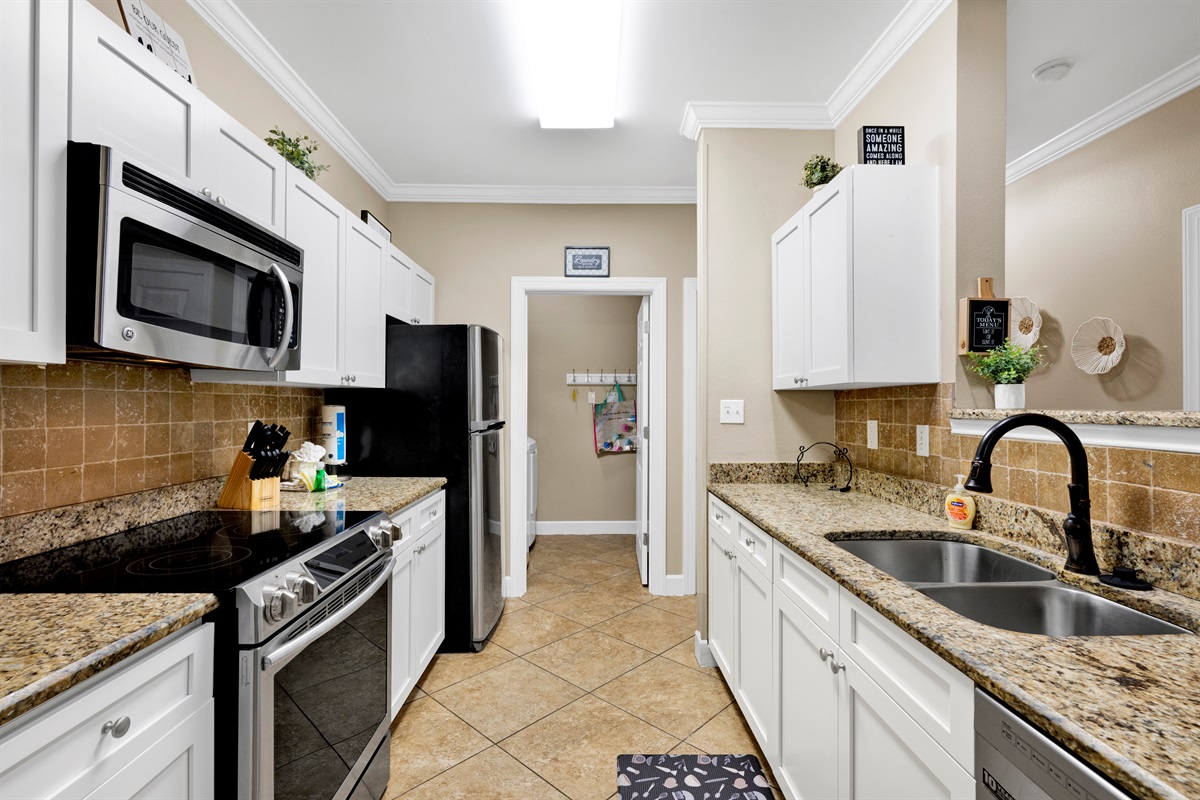 Kitchen with granite tops, stainless appliances and it is fully stocked with everything you need to prepare your meals 