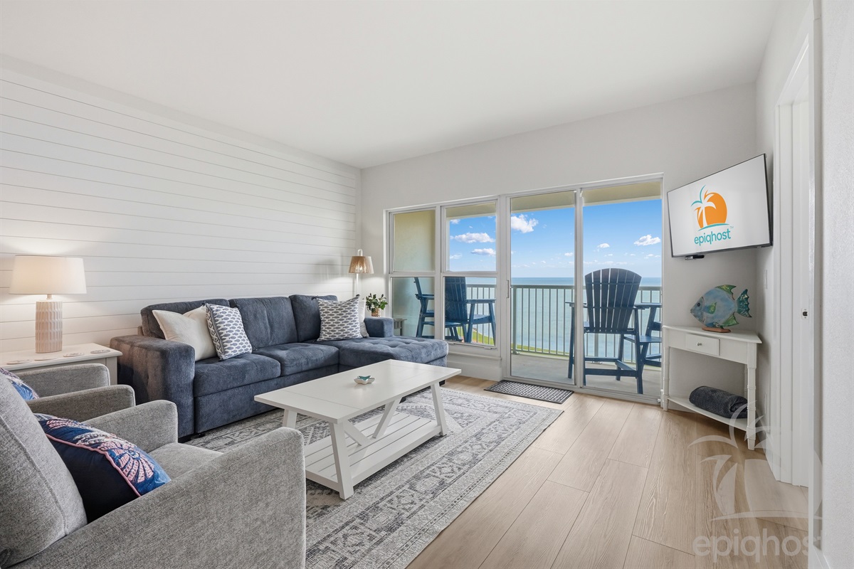 Living room with sectional and bay views