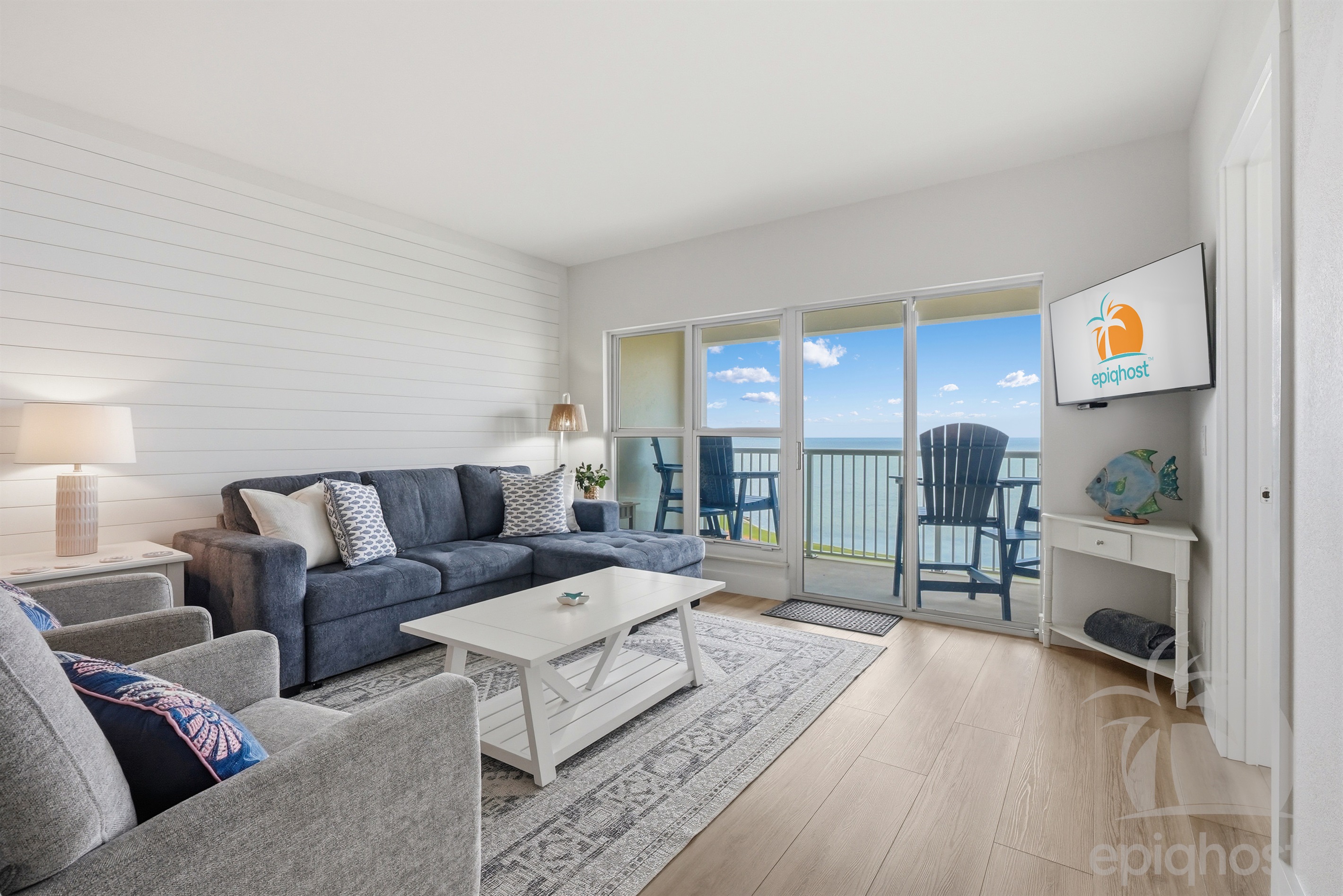 Living room with sectional and bay views