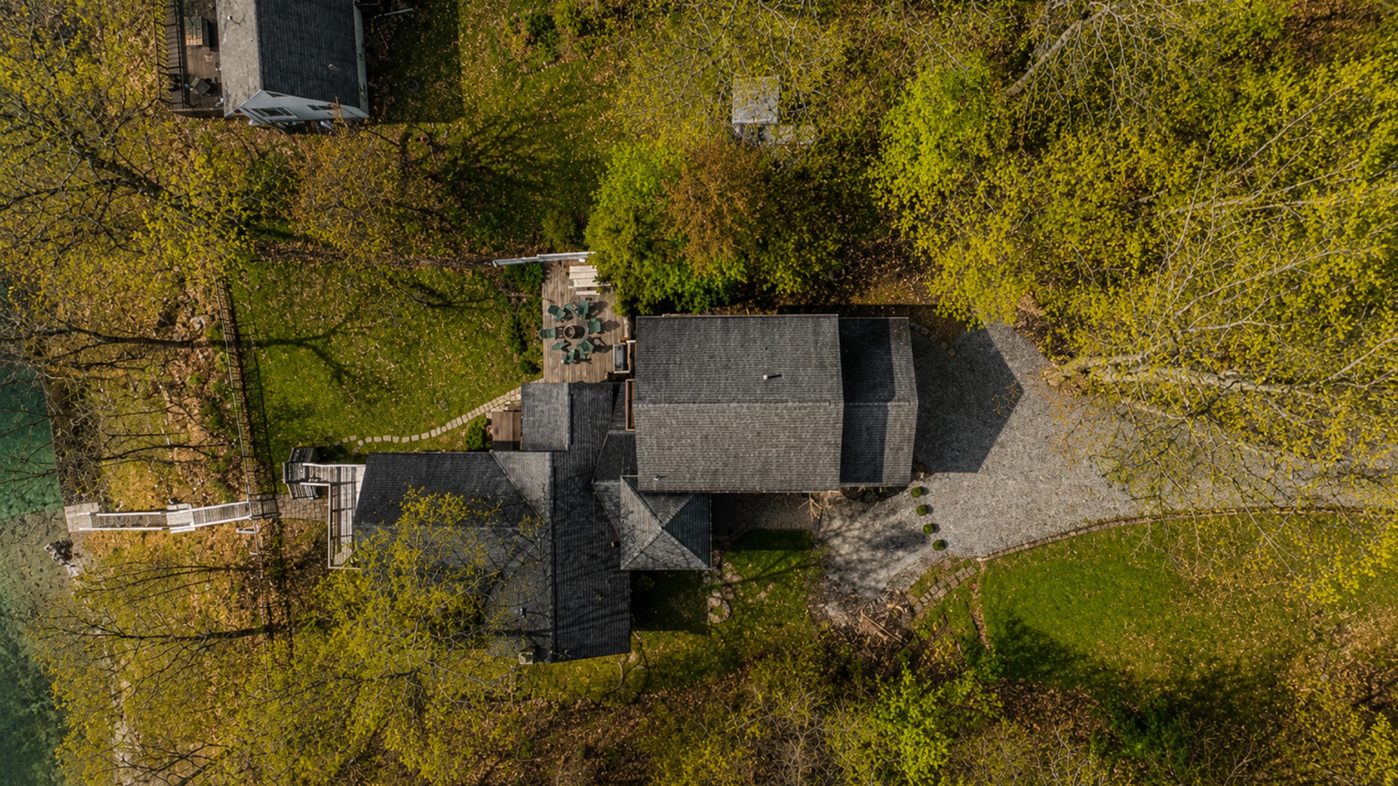 Experience this expansive property from a unique aerial perspective, showcasing its lush green spaces and multiple structures, perfect for large gatherings or peaceful solitude. 