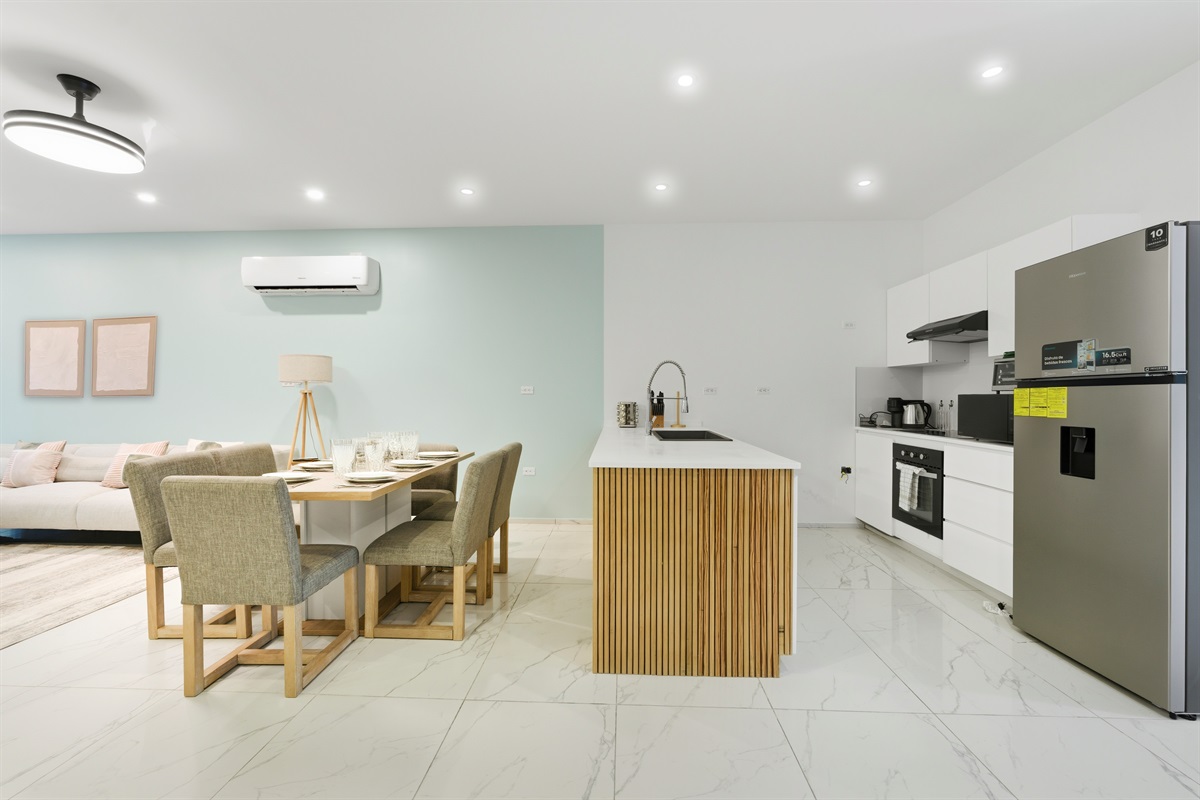 A modern, chef-ready kitchen with stainless appliances and wood-slat island detailing