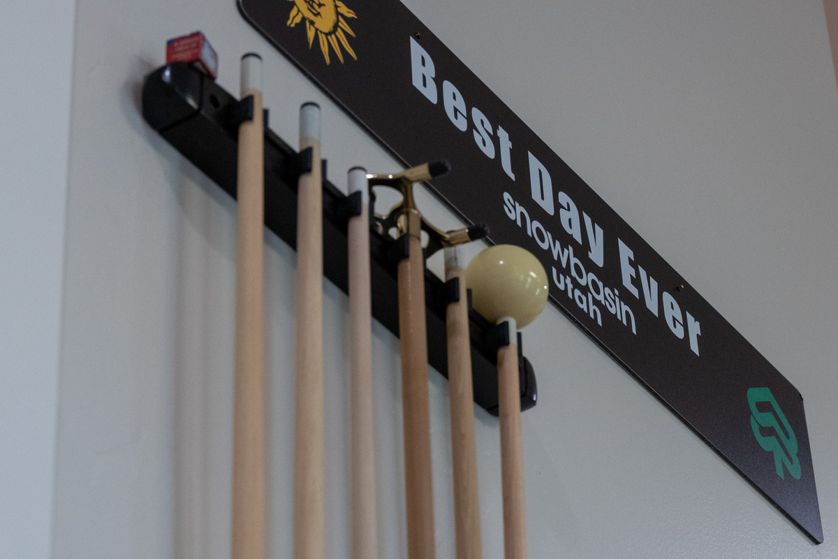 Challenge friends to a game of pool with a full set of cues and equipment ready to go.
