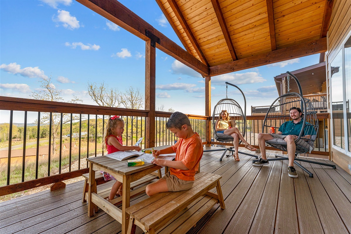 Enjoy the covered deck with hanging lounge chairs, the perfect spot to unwind, take in the views, and spend time together.