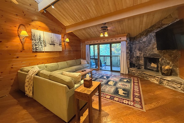 Gather, unwind and take in the view in this    open living room with fire place