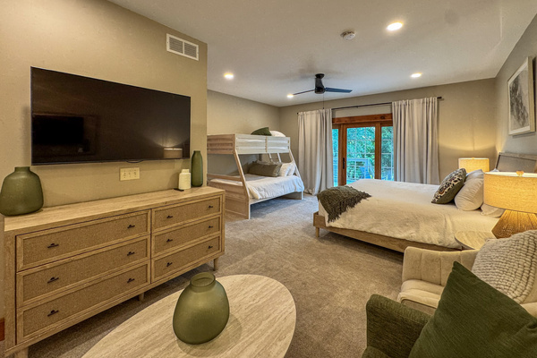 One of our two Jack and Jill bedrooms, each with a king bed and a queen-and-twin bunk bed. The two rooms have matching, mirrored layouts.