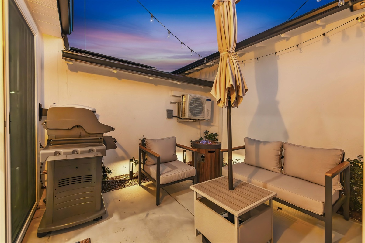 Side patio with bbq, seating and fire table