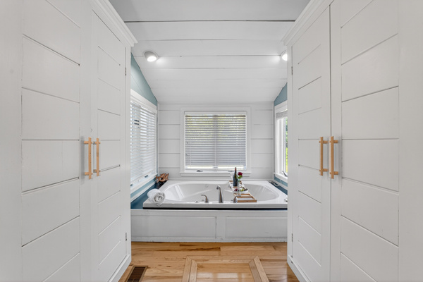 Spa-inspired bathroom featuring a soaking tub, double vanity, and plenty of storage for your stay.