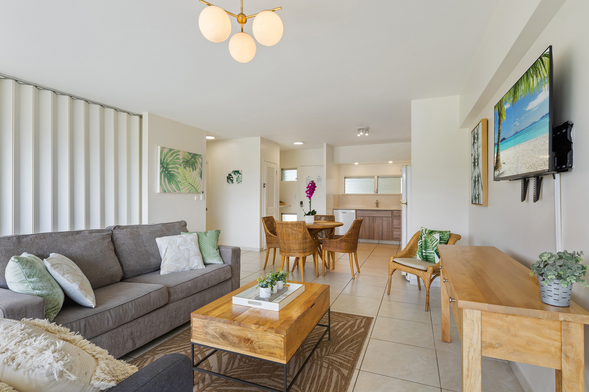 Living area with single side chair, queen sofa sleeper and flat screen TV