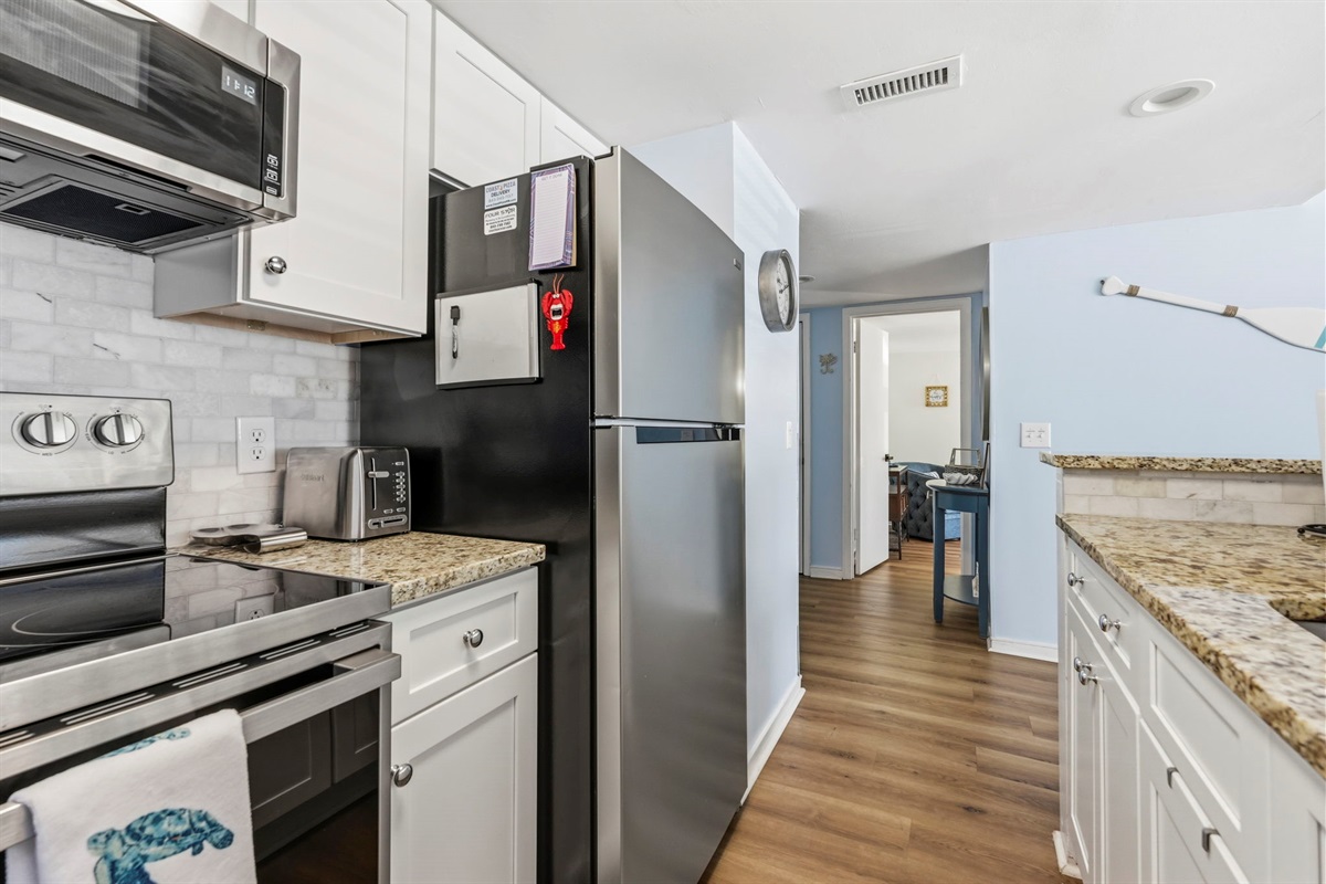 Full kitchen with stainless steel appliances and granite countertops
