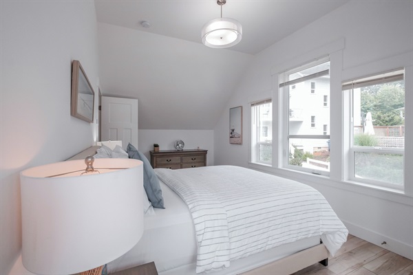 A naturally bright, inviting bedroom designed for comfort and relaxation. 
