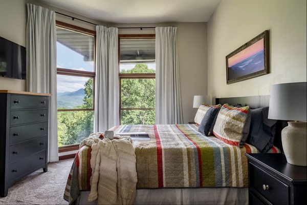 Comfortable king bed with stunning Smoky Mountain backdrop.