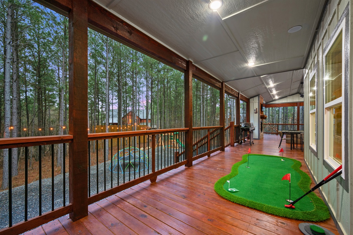 A small putting green on the deck adds a fun activity for guests of all ages, making it easy to enjoy a quick round without ever leaving the cabin.