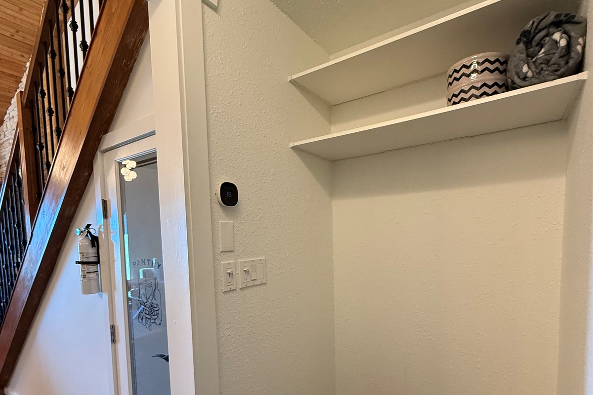 Mudroom Access: The open entryway provides a clear path to the main floor and staircase, with integrated shelving for additional storage solutions.