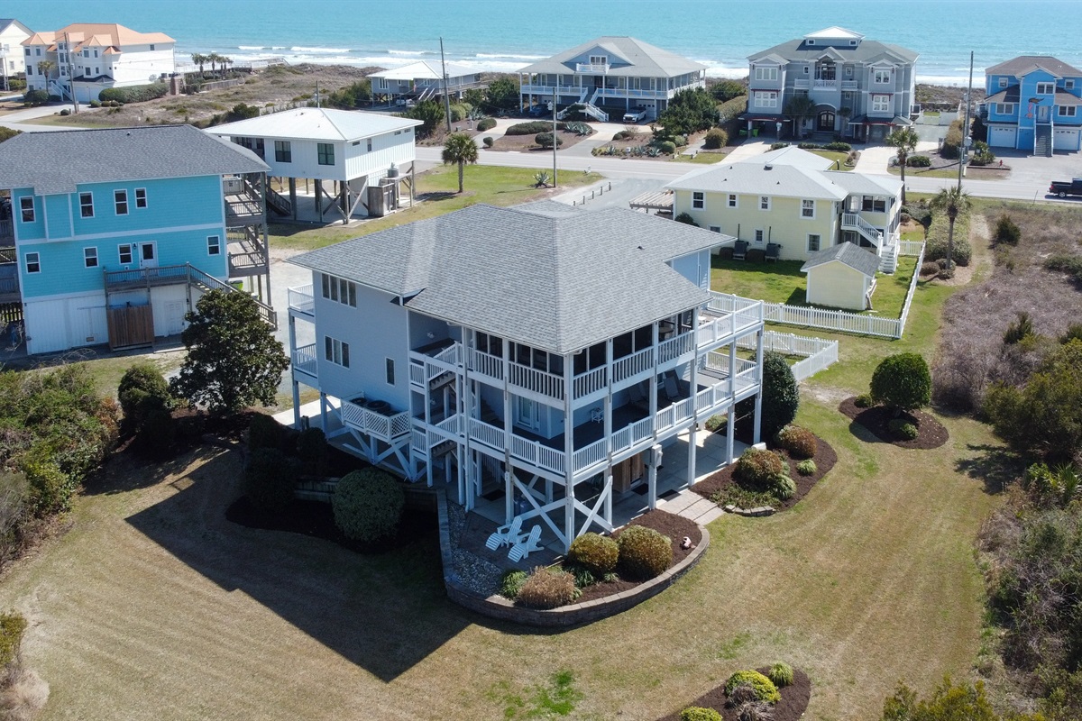 Side aerial view showing decks screened porch and backyard