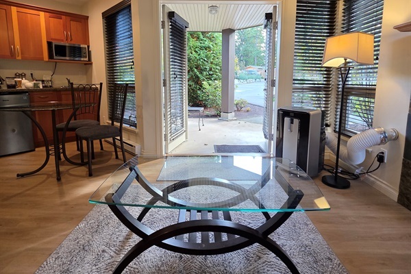 Double glass doors opening to Covered patio with outdoor seating in Unit B.