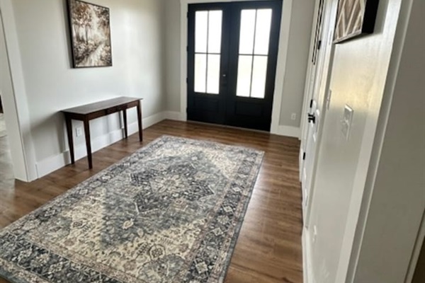 Welcome! Our large double front doors open toward the grand staircase and open living room/kitchen area, with the library/music room on the right when you enter.