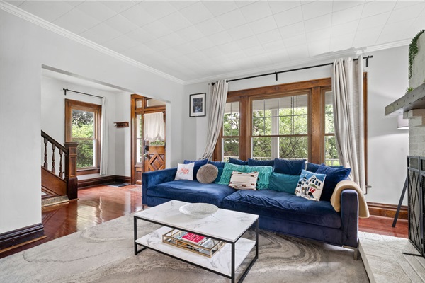 As a part of Clintonville's renowned family-friendly community, our home exudes warmth and character, reflecting the area's rich history. Step into a piece of the past with a large oversized sofa, swivel chair, 55 inch TCL 4K Smart TV, and windows for days