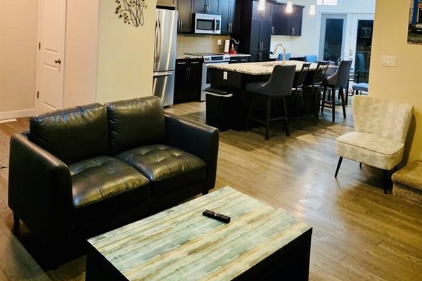 Modern open-concept kitchen and cozy lounge with island seating