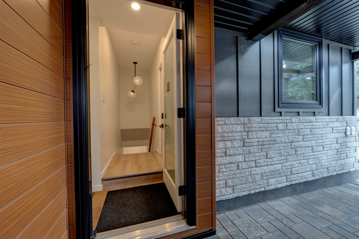Stairway down to the suite — shoe storage is just inside the door to the left.