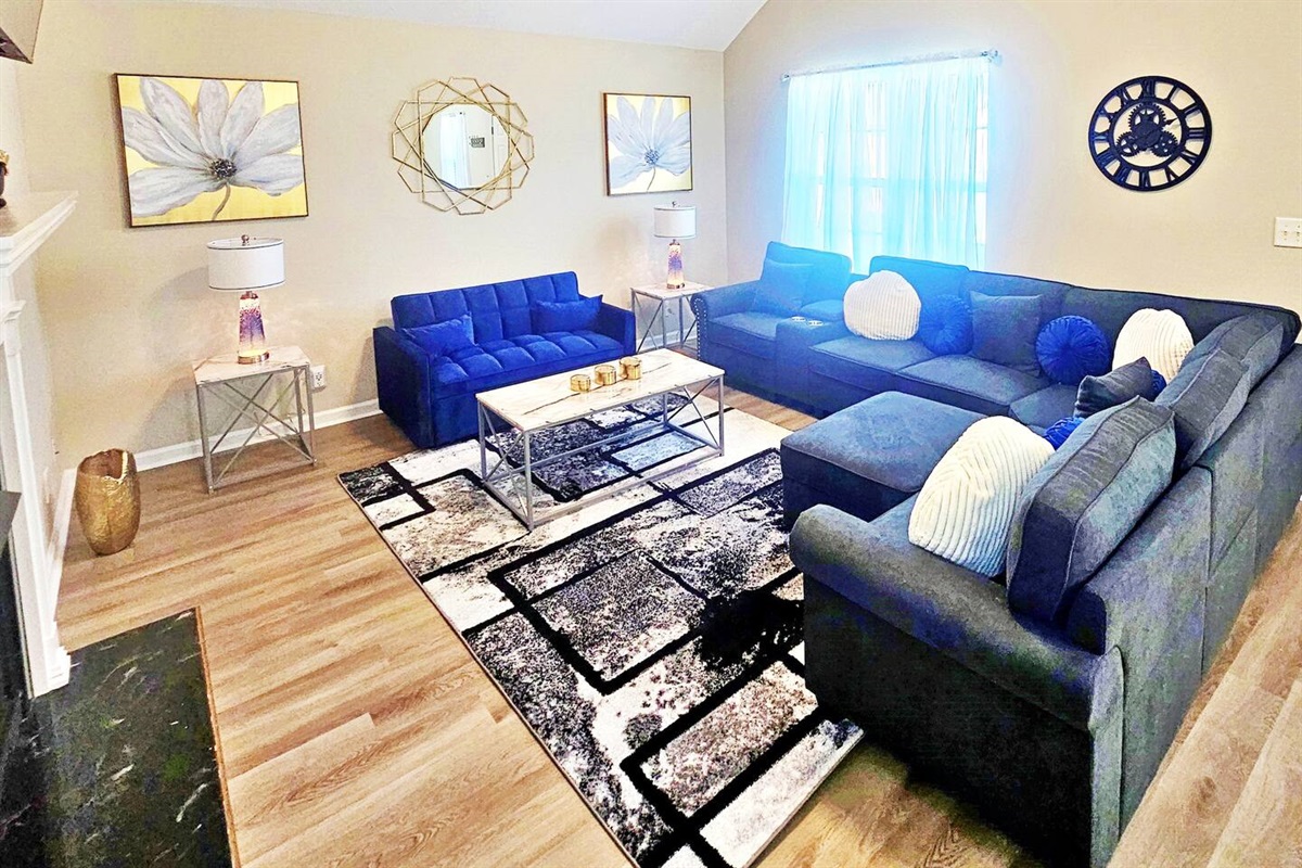 Kick back, relax in this comfy living room, and watch your favorite movie or show on the 50-inch flat-screen smart TV. Blue sofa is a pull-out sofa bed. 