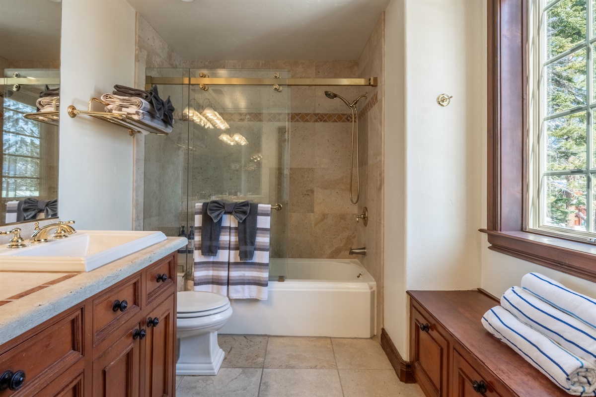 The Moose's ensuite bath with double vanity and tub/shower combo—finished with warm materials and generous counter space.