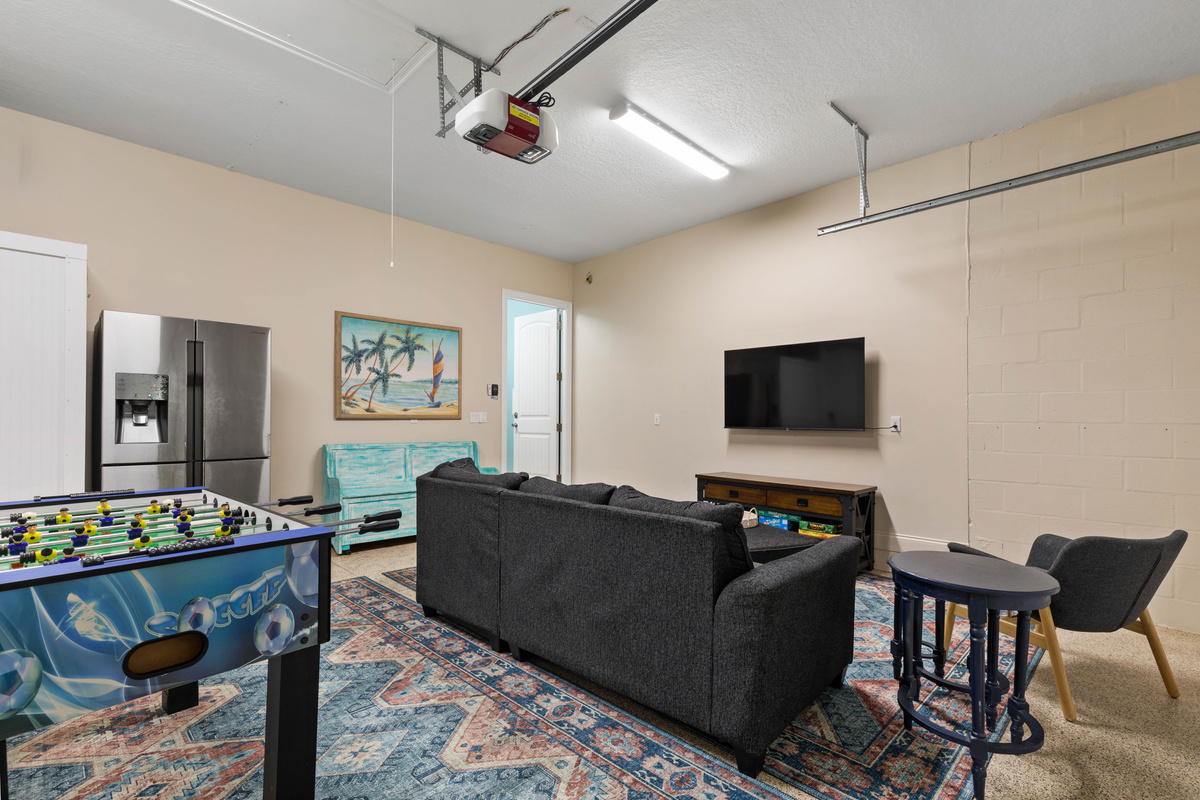 A second fridge, a TV and a big sectional in the game room keep cold drinks and comfy seats close on long game nights.