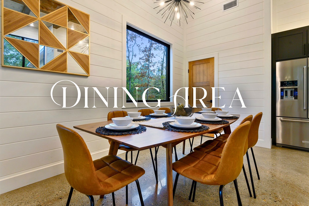 Tucked into a bright corner, this cozy dining space with leather chairs and forest views is ideal for mealtime and board games.