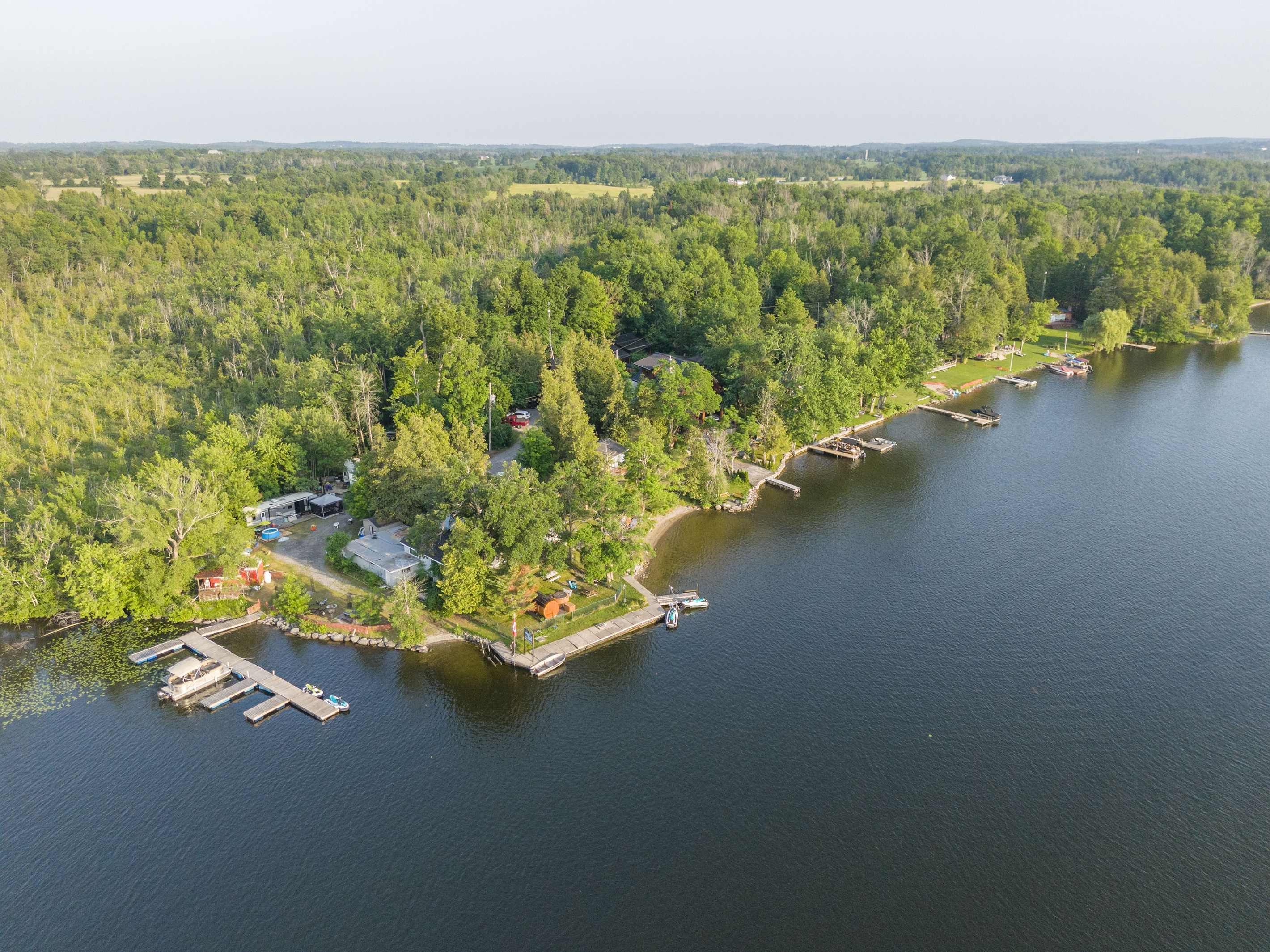 Wide aerial view of the forested waterfront property