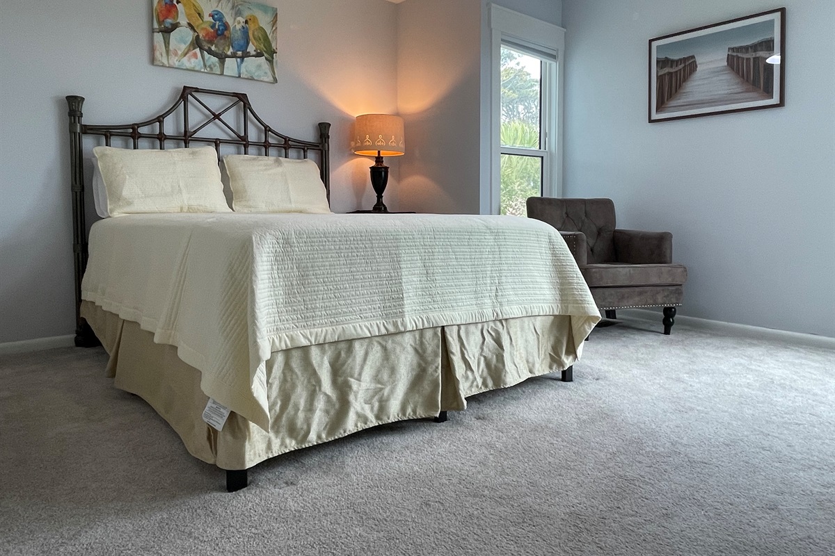 One of two main floor guest rooms, each featuring a queen bed, and ocean view. 