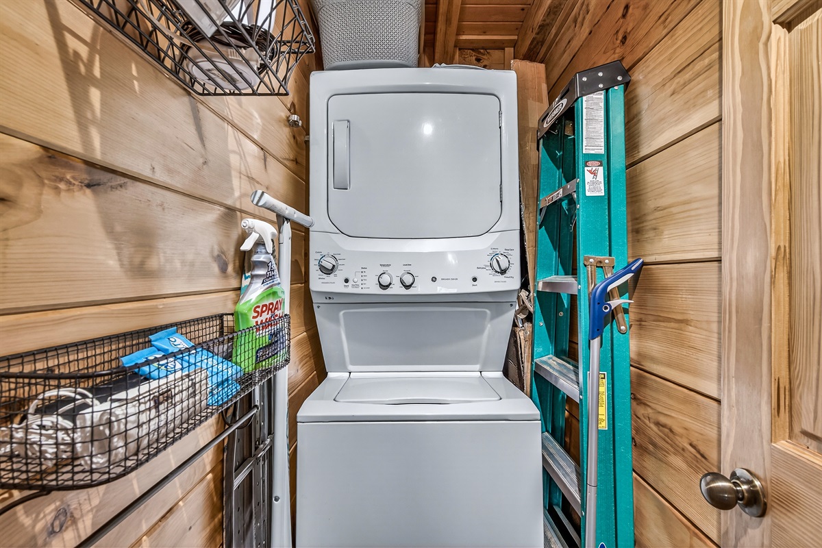 Laundry room includes a laundry basket, an iron, ironing board, steamer, and mop. Starter amount of laundry pods included.