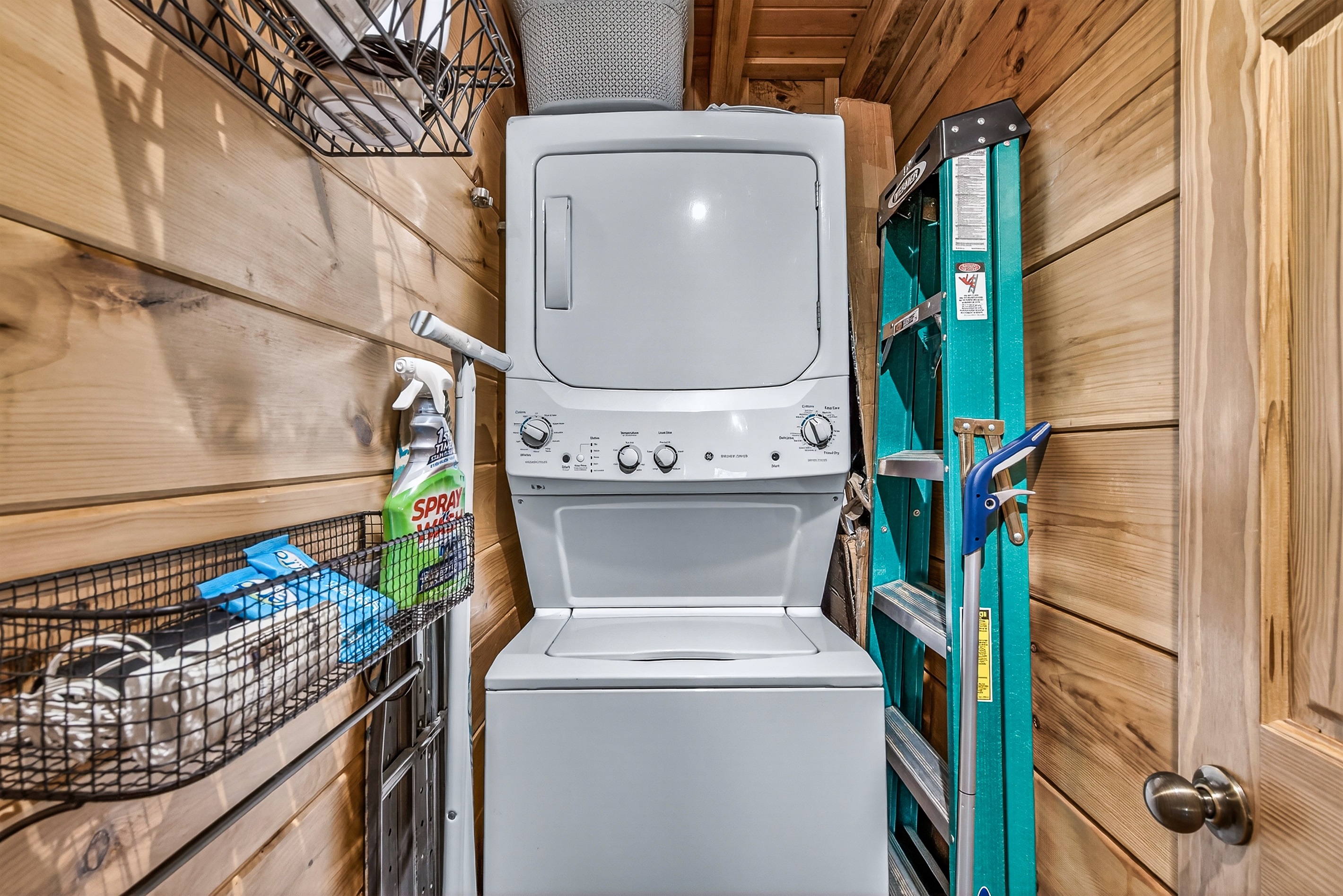 Laundry room includes a laundry basket, an iron, ironing board, steamer, and mop. Starter amount of laundry pods included.